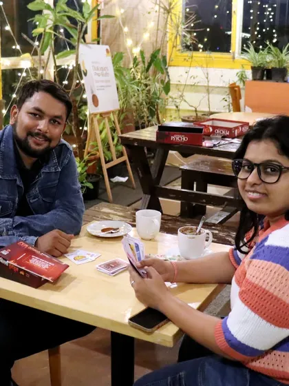 A couple enjoying a quiet game of cards. Our cafe is a great place for a fun and casual date night.