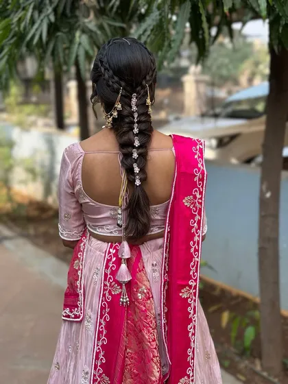 A view of the beautiful braided hairstyle for the Path Muhurat. The delicate accessories add a touch of elegance to the traditional look.