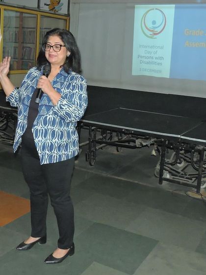 A school leader addresses the students during the Disability Day assembly, speaking about the importance of creating a kind and inclusive world for everyone.