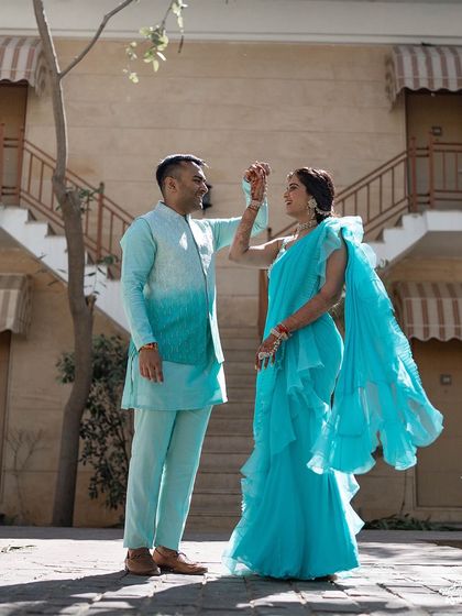 A stylish portrait of the couple in their coordinated turquoise outfits for their Mehendi event at The Westin Pushkar.