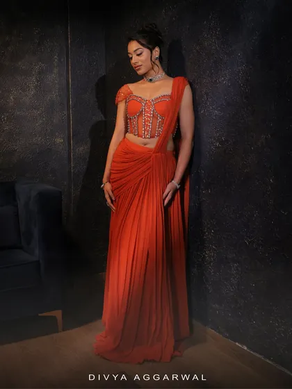 The orange concept saree, designed to be a standout piece. The full-length view shows its elegant drape and striking color.
