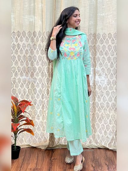 A closer look at the mint green embroidered Anarkali. The soft pastel color and intricate threadwork make it a beautiful and unique choice for any festival.