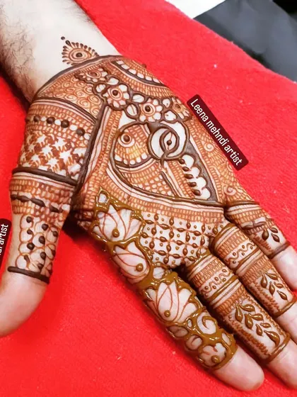A groom's mehndi design. It's a full-palm design that is masculine yet artistic, featuring a large paisley motif.
