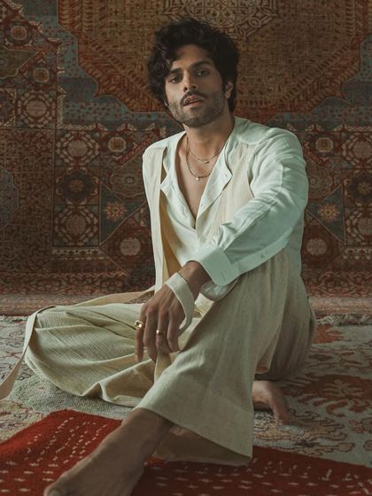 The full look of the layered white ensemble, showcasing its relaxed yet sophisticated silhouette. This is bespoke artistry that tells a story.