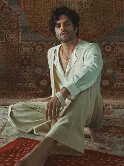 The full look of the layered white ensemble, showcasing its relaxed yet sophisticated silhouette. This is bespoke artistry that tells a story.
