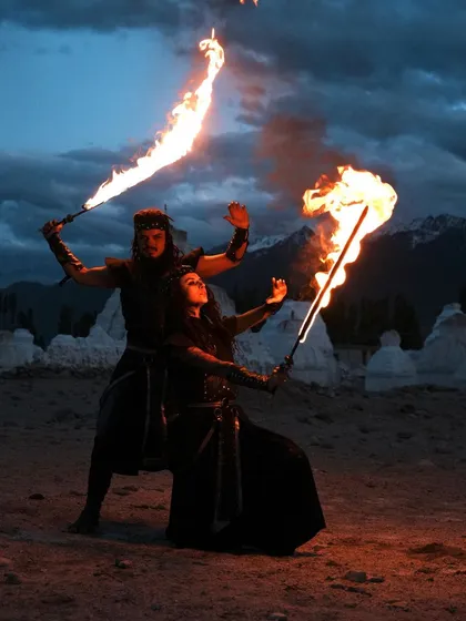 A duo performance set against a dramatic twilight landscape. We use fire swords to paint the air with light, creating a choreographed story of conflict and harmony. This is an example of our site-specific, epic storytelling shows.