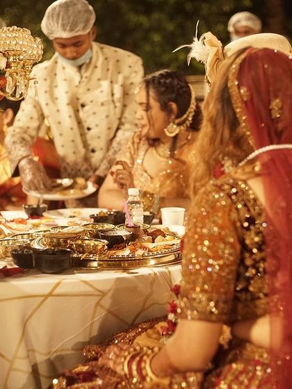 A beautiful moment captured at a wedding dinner I catered. The couple is enjoying their meal as my staff serves them at their table, ensuring a special experience.