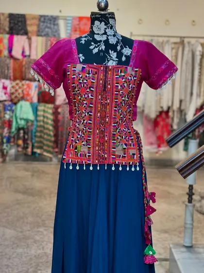 The vibrant colors and traditional embroidery make this a standout piece.