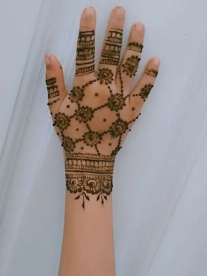 A delicate and pretty net design for a child's hand. This style is light and elegant, making it a perfect choice for a young guest at a wedding or party.