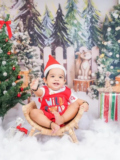 Waving hello from a winter wonderland. This Christmas baby photoshoot captures the magical feeling of the holiday season.