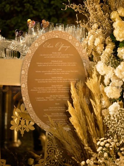 The bar menu for the Sufi night, presented on an elegant oval board and framed by beautiful dried and fresh floral arrangements.