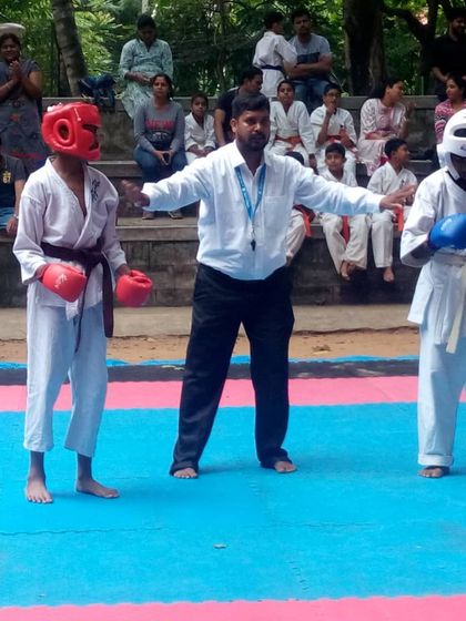 I officiate a match between two young students. It is important to guide them through the rules and pressures of competition.
