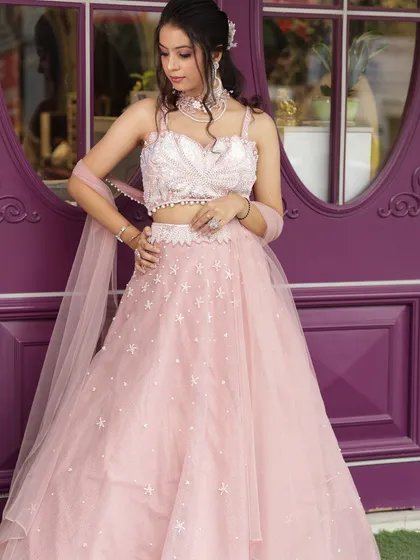 A perfect bridesmaid or engagement look featuring our light pink lehenga with star embellishments. It's a youthful and dreamy option for your portfolio.