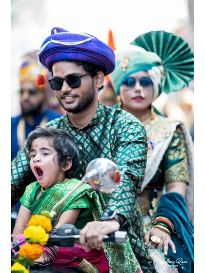 A family enjoying the Gudi Padwa festival together on a motorcycle. The little one's candid yawn adds a touch of real life and humor to this vibrant cultural portrait.