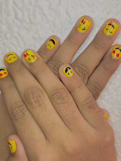 It's time to pamper your little ones. I offer fun and safe manicures for kids, like this adorable emoji-themed nail art on a bright yellow base.