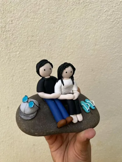 This cute couple miniature is created on a natural stone, perfect as a standalone keepsake or as part of a larger garden arrangement.