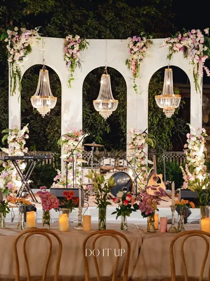 An elegant outdoor dinner in Jaipur. I used classic archways and crystal chandeliers to frame the stage, creating a sophisticated and timeless backdrop for an evening of live music and celebration under the open sky.