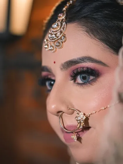 A close-up shot focusing on the bride's stunning eye makeup and jewelry. These detail shots are essential for telling the complete story of her bridal transformation.