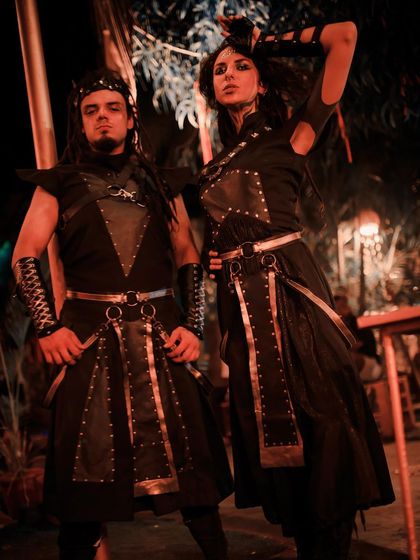 A full view of our warrior duo's costumes, featuring leather, studs, and custom armor pieces. This theme is perfect for medieval fairs, fantasy conventions, and themed parties.