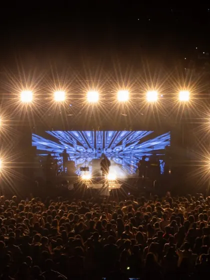 Capturing the full scale of a live event, this shot shows the entire stage setup for Amit Mishra's concert, with dramatic lighting and the energy of the audience.