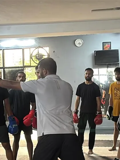 A wider view of a group lesson. All eyes are on the demonstration as I break down the mechanics of a punch. This focused learning environment is key to my coaching style.