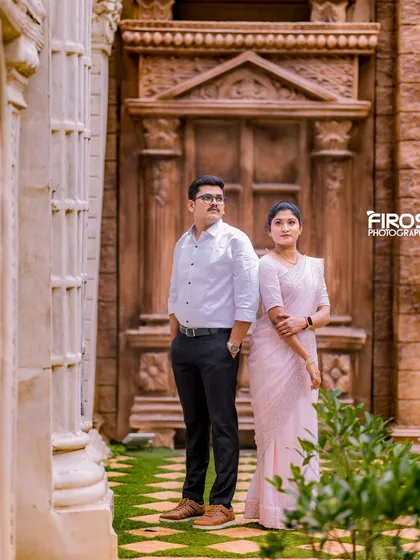 A stylish pose in front of a grand, carved wooden door, adding a sense of timeless elegance.