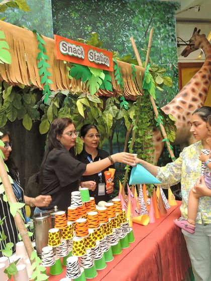 The 'Jungle Joyland' snack station was a big hit. Here, a mother and her child enjoy the themed treats, part of the immersive and fun-filled day we planned for our families.