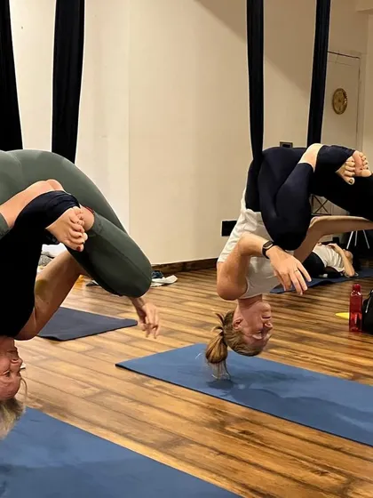 One of the most exciting parts of our curriculum is Aerial Yoga. In this shot, my teacher training students are practicing an inverted Baddha Konasana (Bound Angle Pose) in the silks. This not only builds incredible core strength but also helps decompress the spine and see the world from a new perspective.