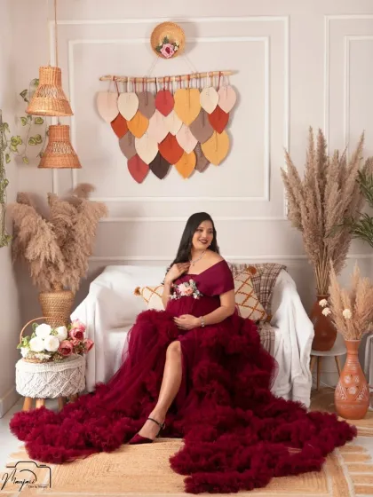 A full view of the gorgeous wine-colored gown in the boho setup. This portrait exudes confidence and elegance.