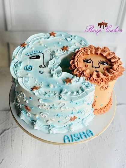 A whimsical sun and moon cake for Aisha. This unique design features two interconnected cakes representing day and night, decorated with dreamy, artistic faces and starry details.