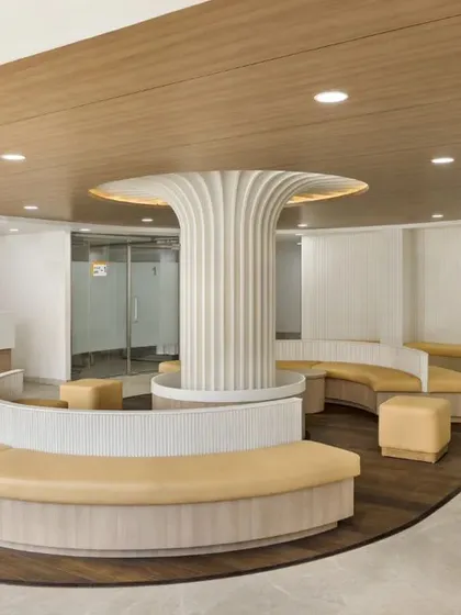This waiting area at SPS Hospital Clinic is defined by its organic forms and warm, earthy tones. The design creates a nurturing and calm environment, moving away from the traditional, rigid feel of clinical spaces.