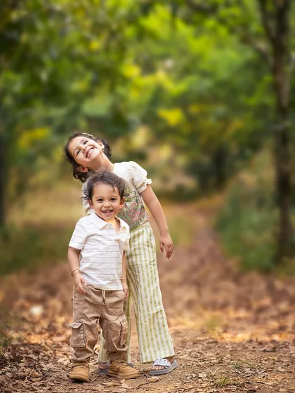 Sometimes the most magical moments are the most natural ones. For this sibling photoshoot, we chose a simple path in the woods, letting their happy energy and bright smiles create a perfect, heartwarming memory of childhood.