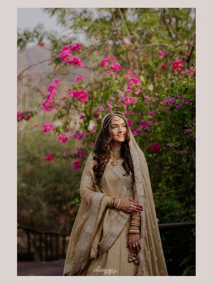 A bridal portrait in a garden, with the bride bathed in soft, natural light.