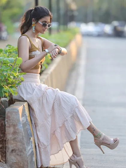 A candid, street-style shot of Shiwani Chakraborty. This captures a natural, in-between moment that feels authentic and unposed.