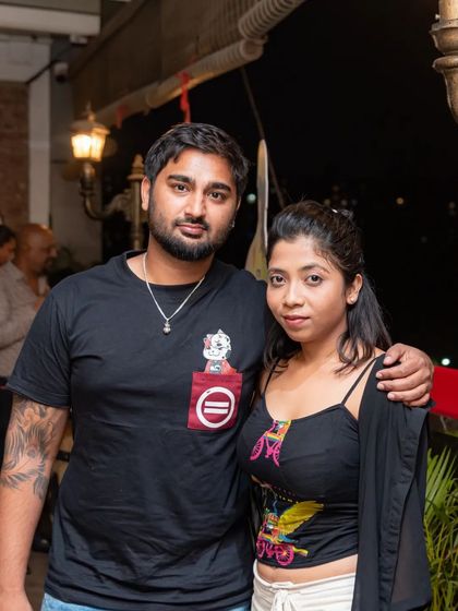 A couple posing together on the rooftop.