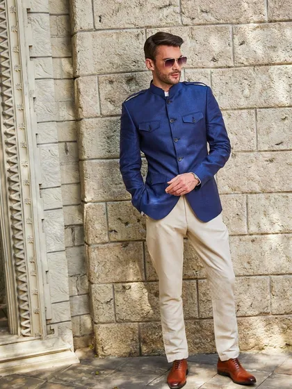 A full-length view of the cobalt blue linen jacket paired with beige breeches. This combination is bold, fashionable, and perfect for making a statement.