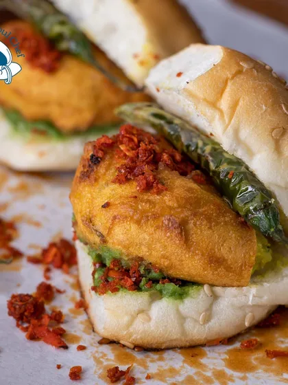 A classic Mumbai street food snack, elevated. My mini Vada Pav is a perfect bite-sized version of the beloved original, complete with spicy chutney and a fried green chili.