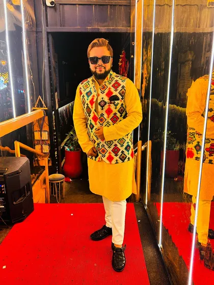 Embracing tradition with timeless elegance. A shot of me in a bright yellow kurta and a colorful jacket, ready for a festive event.