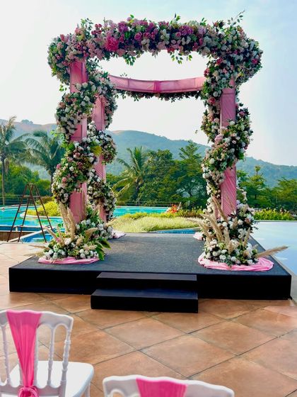 The final look of the pink floral mandap by the pool, ready to host a beautiful wedding ceremony.