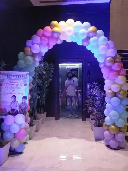 The entrance arch for the Peppa Pig party, made with pastel rainbow balloons.