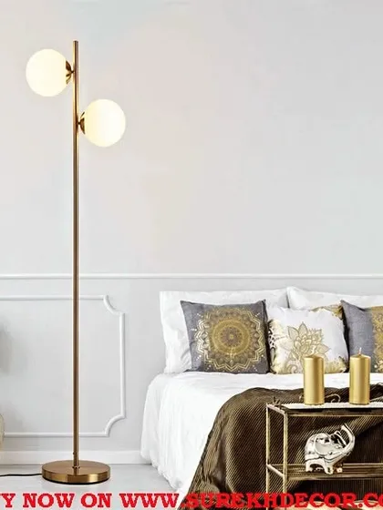 A beautiful shot of our spruce antique brass floor lamp in a bedroom setting. The warm glow of the two globes creates a cozy and inviting atmosphere, perfect for relaxing at the end of the day.