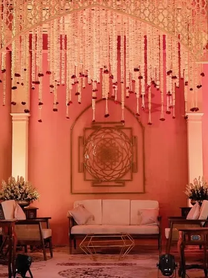 A wide view of the guest seating area, where Shri Yantra symbols adorn the walls and floral chandeliers hang from the ceiling, ensuring the theme is felt in every corner.