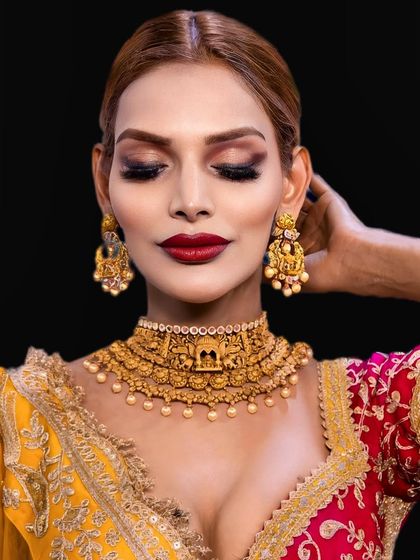 Eyes closed, this shot highlights the beautiful eyeshadow work. The warm, earthy tones are blended seamlessly to create a soft yet defined look.