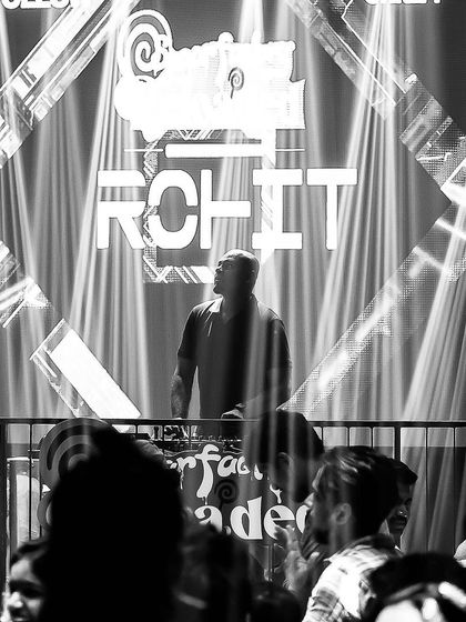 A dramatic black and white shot of me at the console, with my name lit up on the big screen.
