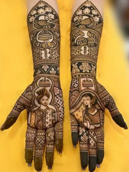 A stunning example of full-arm portrait mehndi. The design includes detailed figures of the bride and groom, framed by peacock motifs and intricate patterns.