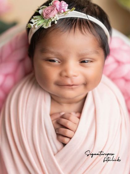 The precious, open-eyed smile of a 20-day-old newborn, a rare and treasured moment captured forever.