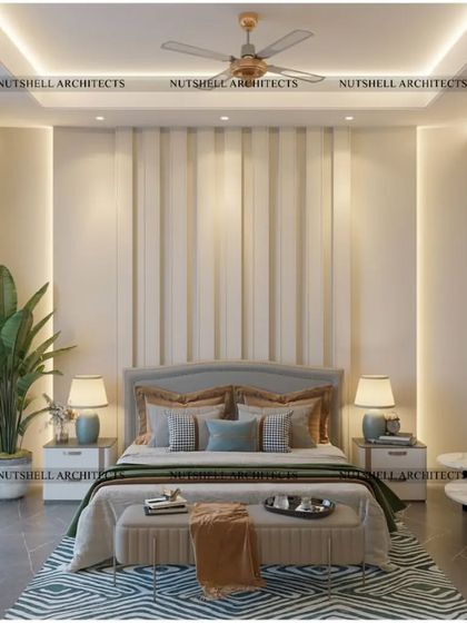 The bed in this parent's suite is set against a backdrop of elegant upholstered panels. A small, comfortable seating area by the window provides a perfect spot for morning coffee or quiet reading.