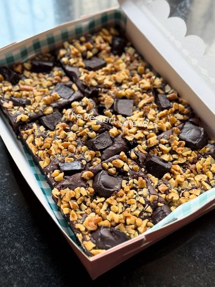 A box full of my irresistible Walnut Brownies. They are loaded with crunchy walnuts and chocolate chunks for the perfect balance of textures.