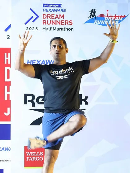 A balance pose to engage the crowd during the pre-race warm-up.