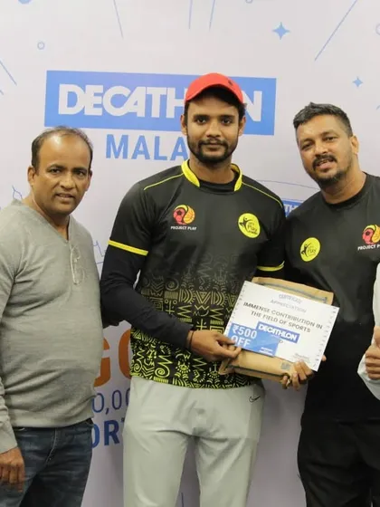 Posing with an award winner holding a Decathlon voucher. We often partner with brands to provide valuable prizes that encourage people to continue their fitness journey.